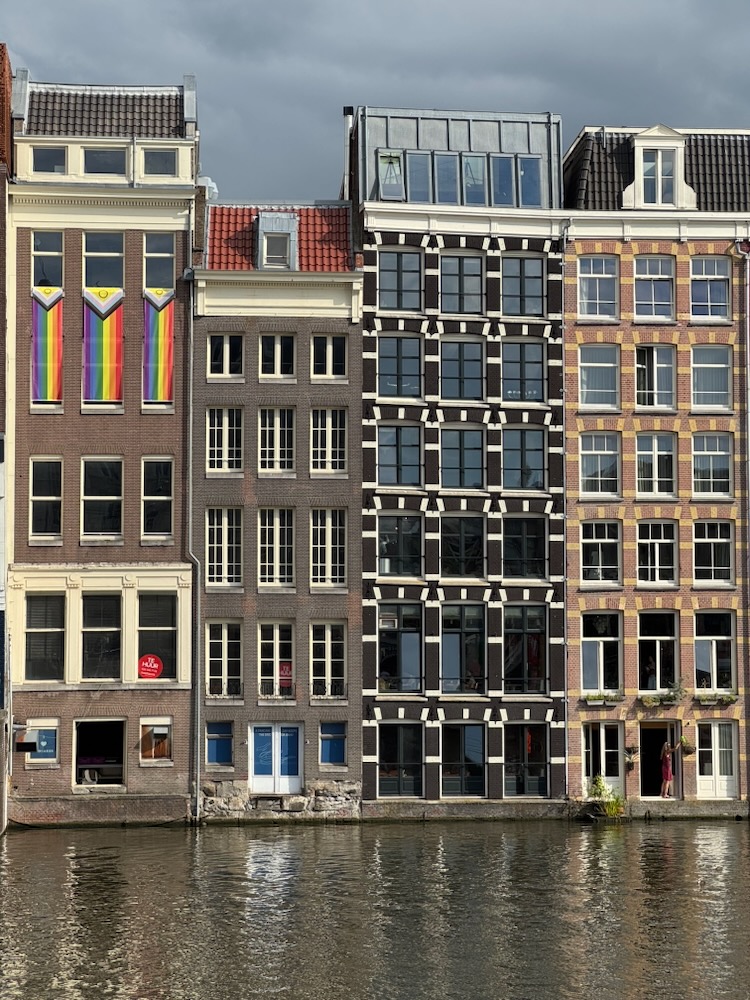 Amsterdam Canal with 3 rainbow flags to celebrate World Pride.