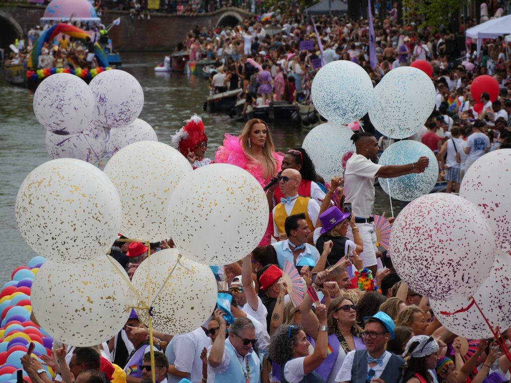 Canal float with multiple glittery balloons during the Amsterdam World Pride 2026 Canal Parade.