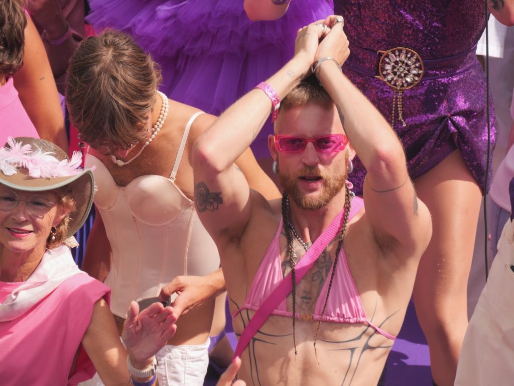 A man dances in his pink bikini at the Amsterdam World Pride 2026 Canal Parade.